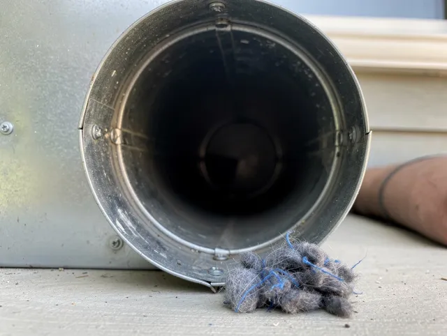 Palm Coast Dryer Vent Cleaning technician using specialized equipment to clear severe dryer vent blockage in Palm Coast